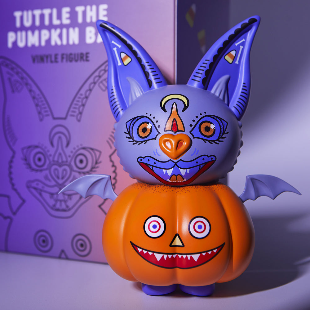 alt="Tuttle the pumpkin bat next to box"