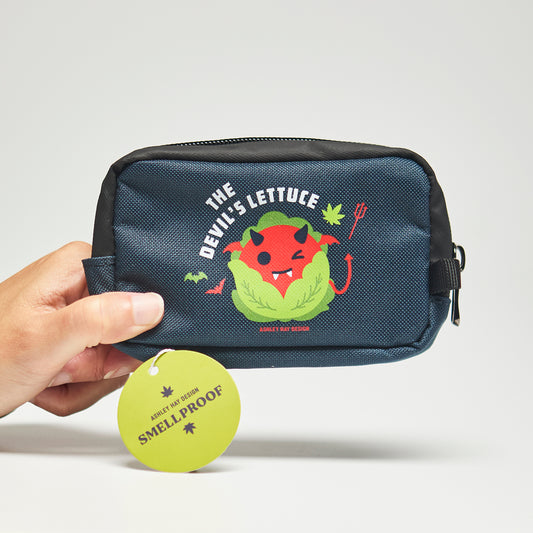 Navy smellproof bag with a cute lettuce character labeled 'The Devil's Lettuce' held by a hand on a neutral background.
