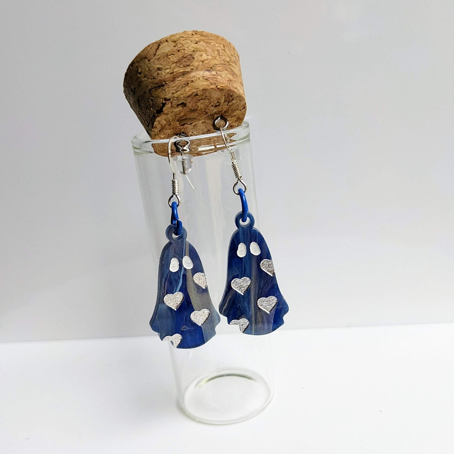 alt="Blue and silver acrylic heart ghost earrings"