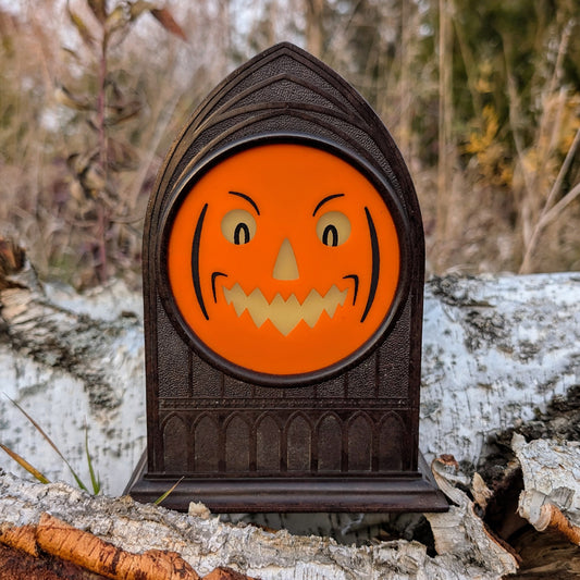 Vintage mantle clock of a Halloween face with an angry smirk outside