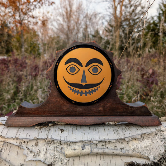 Vintage mantle clock, Halloween face with a mustache outside