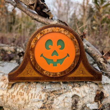 Vintage wood mantle clock with a jack-o-lantern smiling face outside