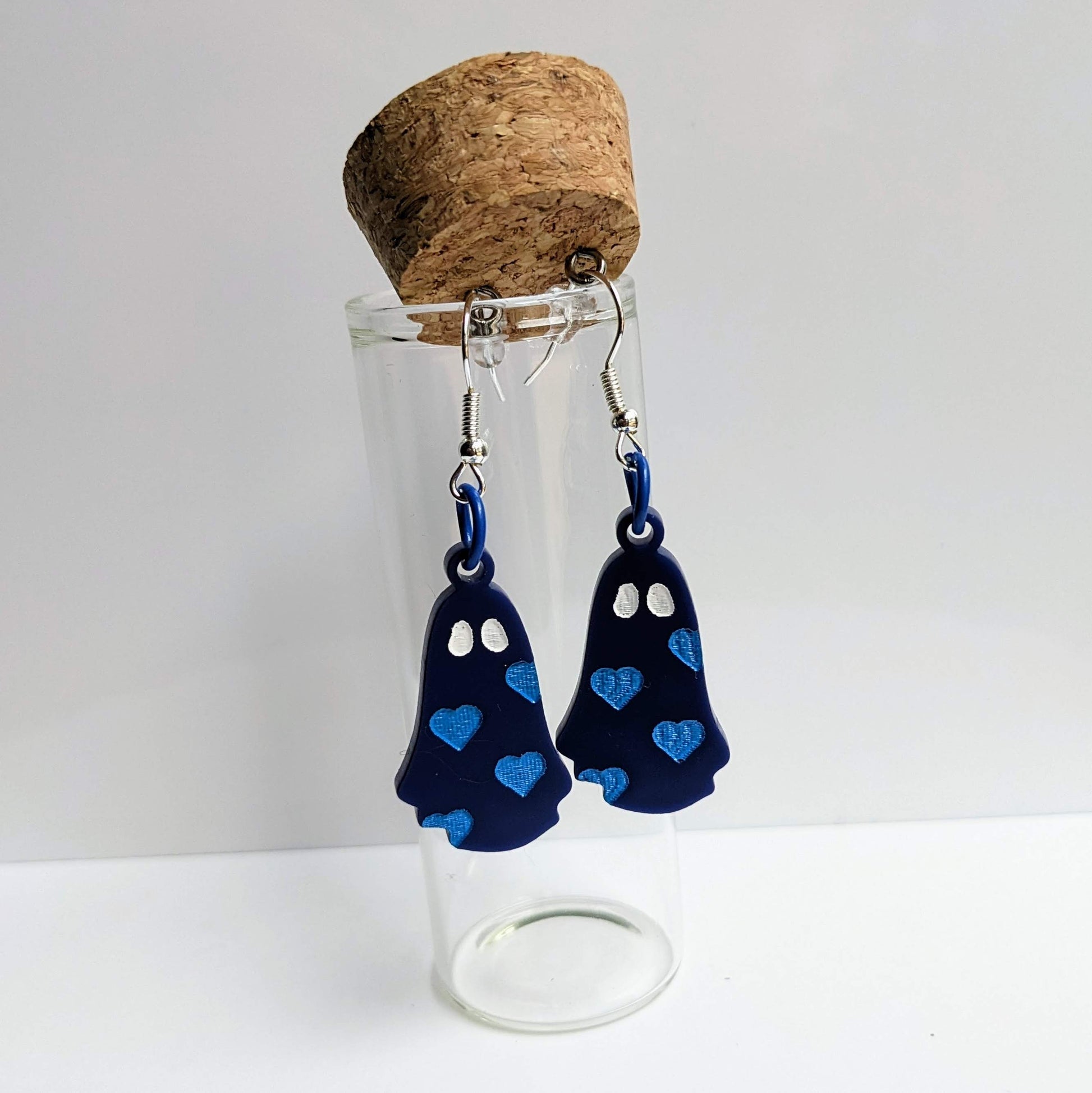 alt="Navy blue acrylic heart ghost earrings"