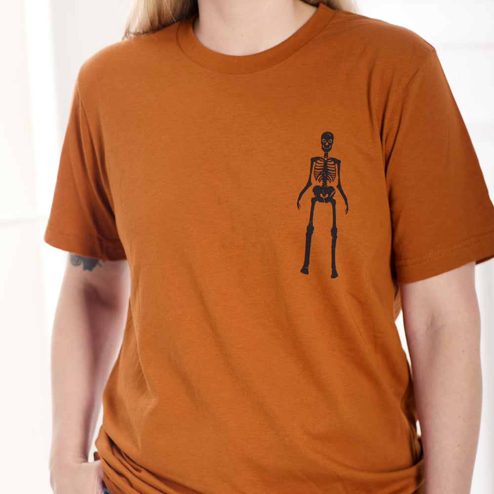 Orange shirt with a skeleton printed on the corner front