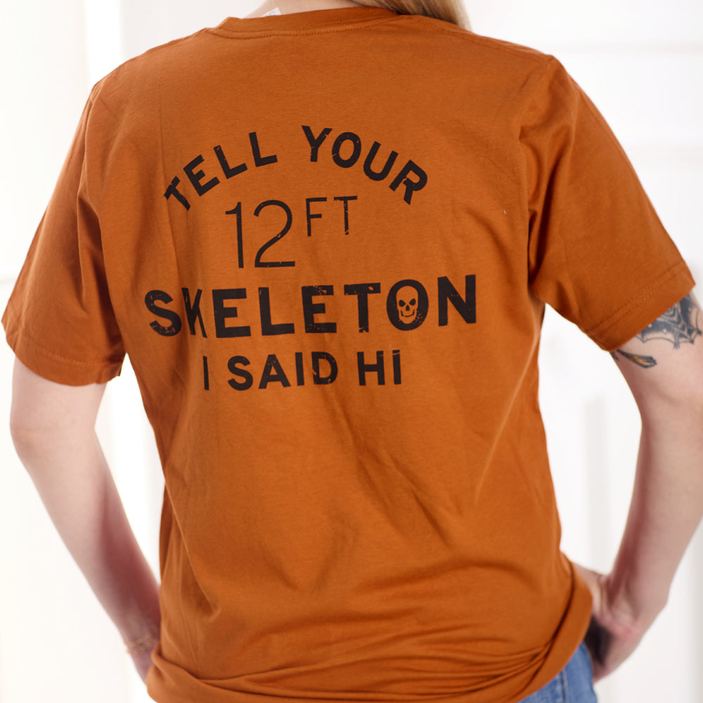 Orange shirt with 12ft skeleton text on the back