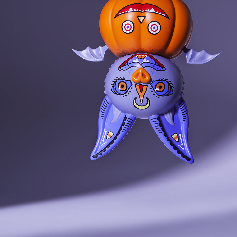 alt="Tuttle the pumpkin bat hanging upside down"