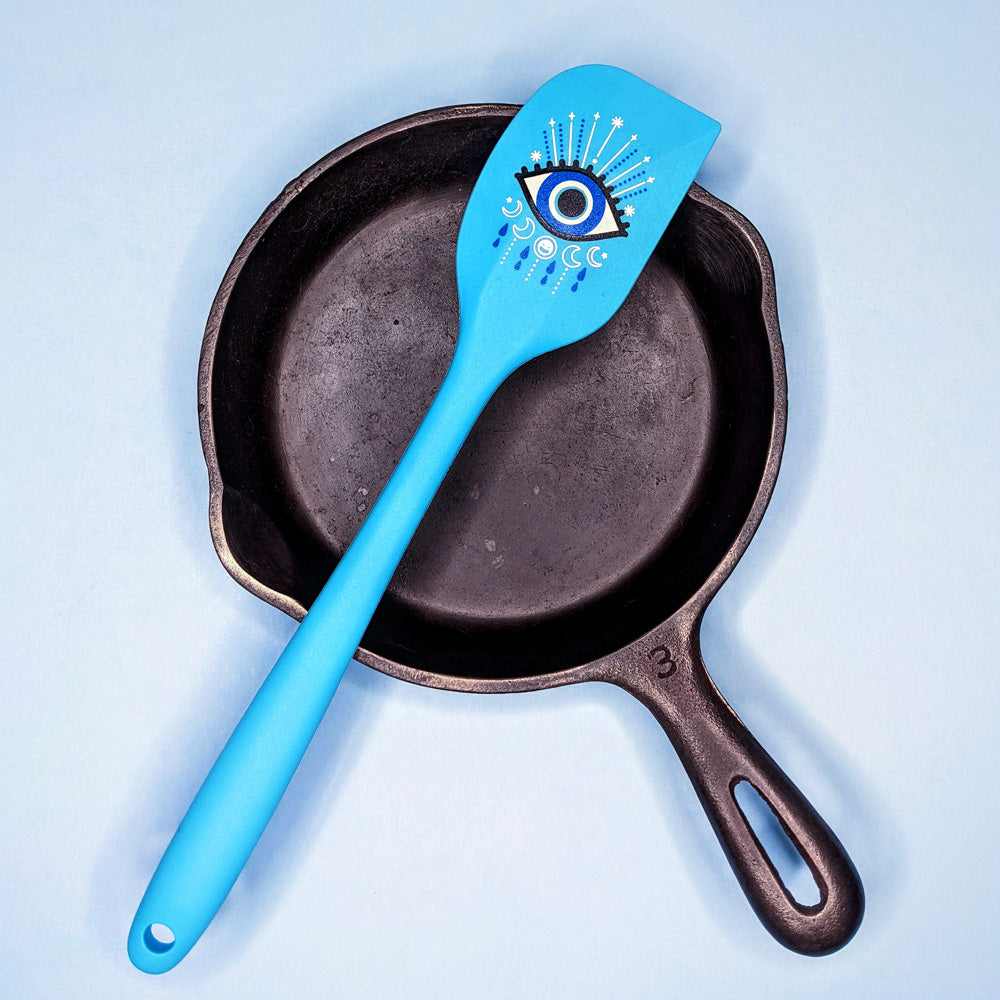 alt="Evil eye blue spatula on pan"